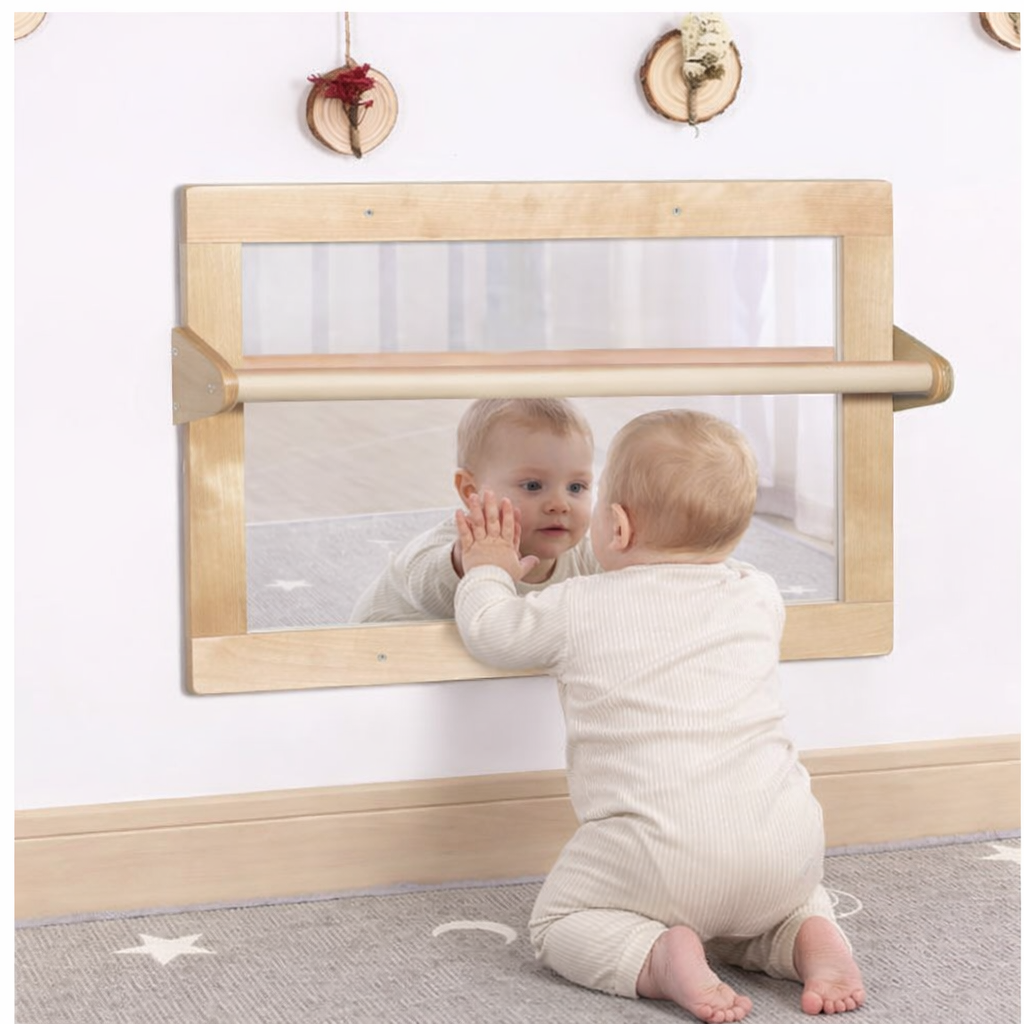 baby looking at a mirror