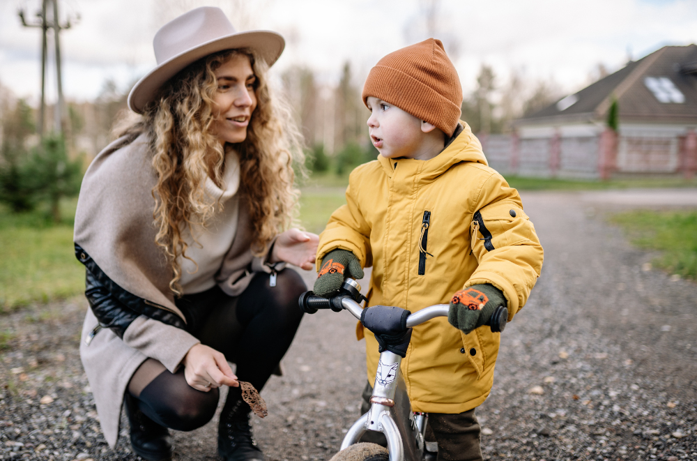toddler on a bike with mother
