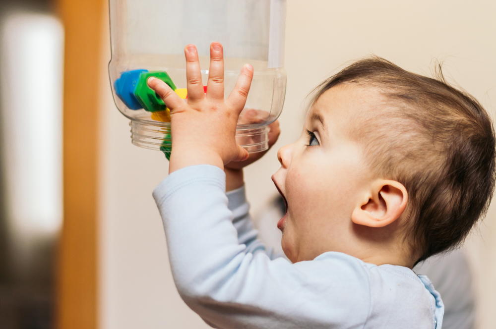 toddler emptying a jar