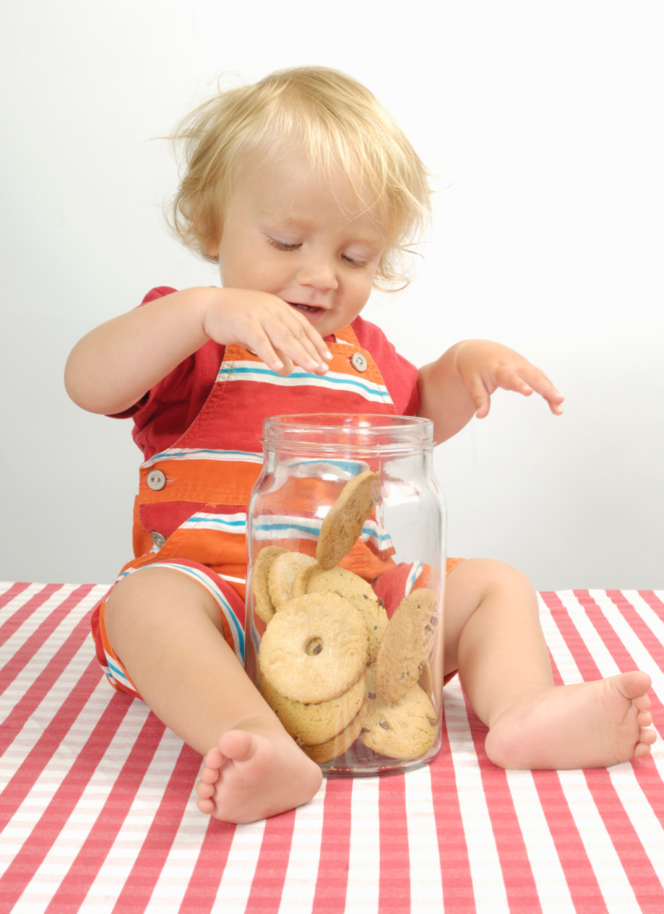 toddler playing with cookie jar