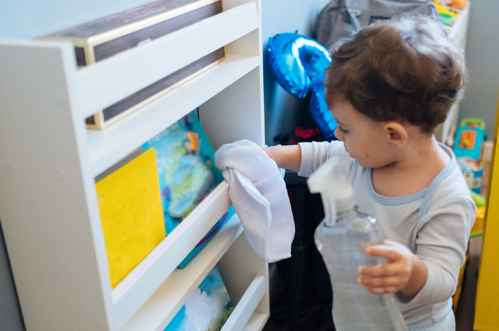 toddler cleaning bookcase