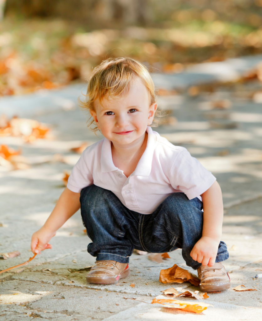 toddler picking leaves