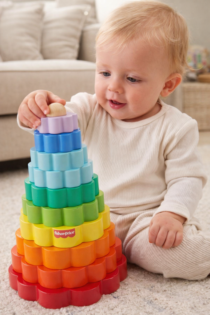 toddler playing with wooden ring stacker