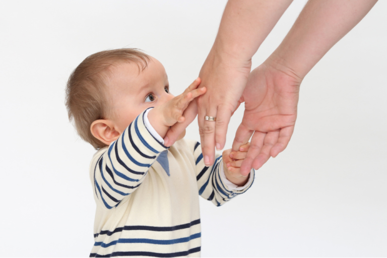 baby reaching for mum