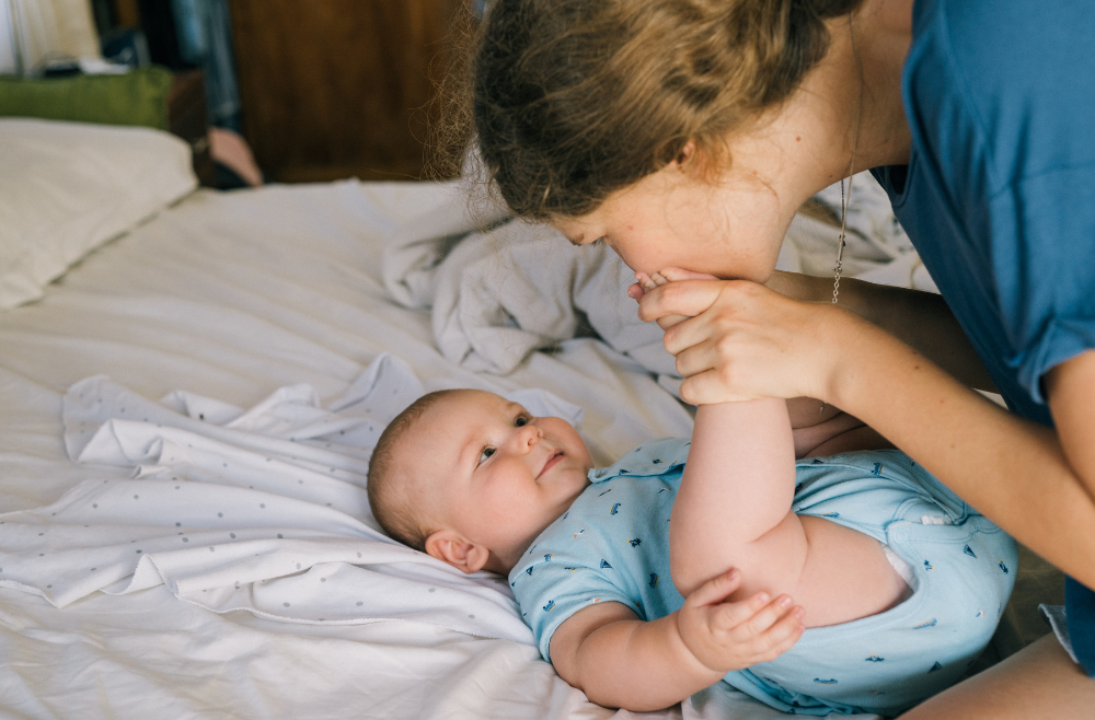 Mother kissing baby's feet