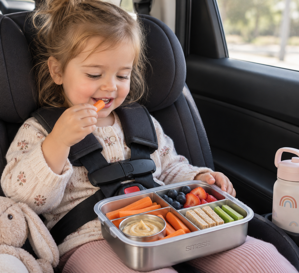 Toddler eating snacks after nursery in car seat.