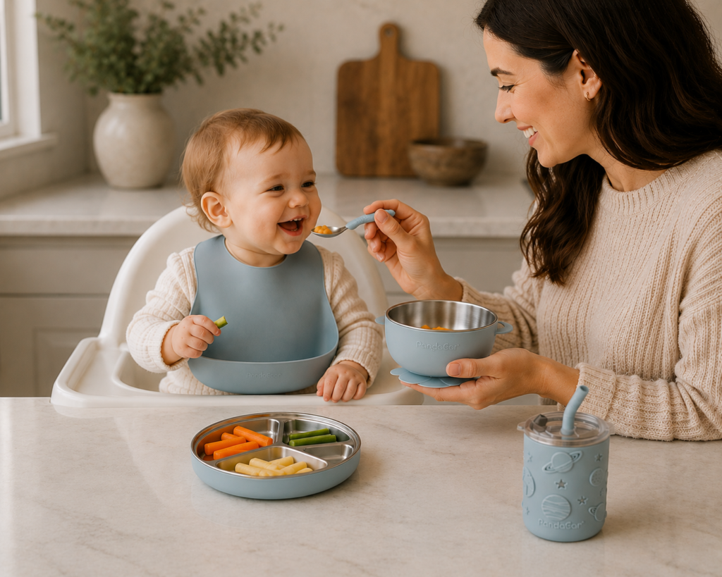 PandaEar stainless steel baby-led weaning set with suction plate, bowl, cup, bib and toddler cutlery during mealtime.