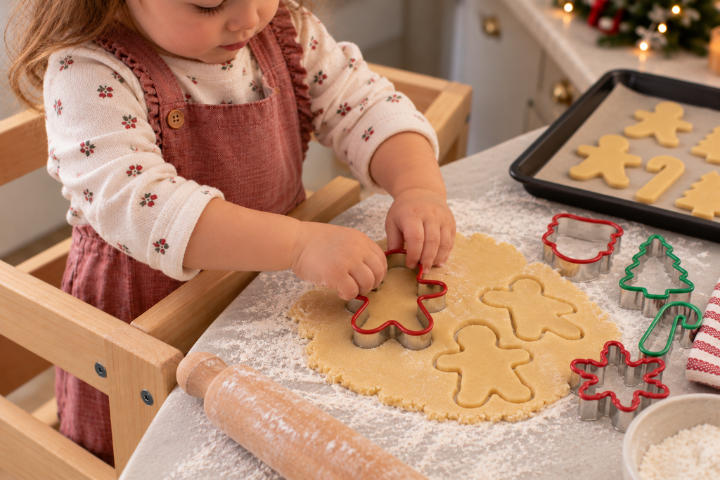Toddler cutting cookie dough with a gingerbreadman cookie cutter.