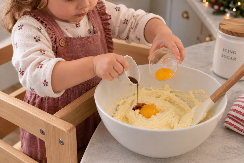Toddler adding egg yolk and vanilla mixture for a simple Christmas cookie recipe.