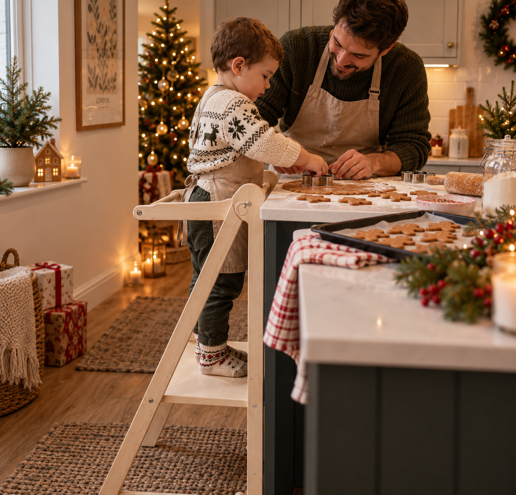Toddler on learning tower helping dad bake Christmas cookies.